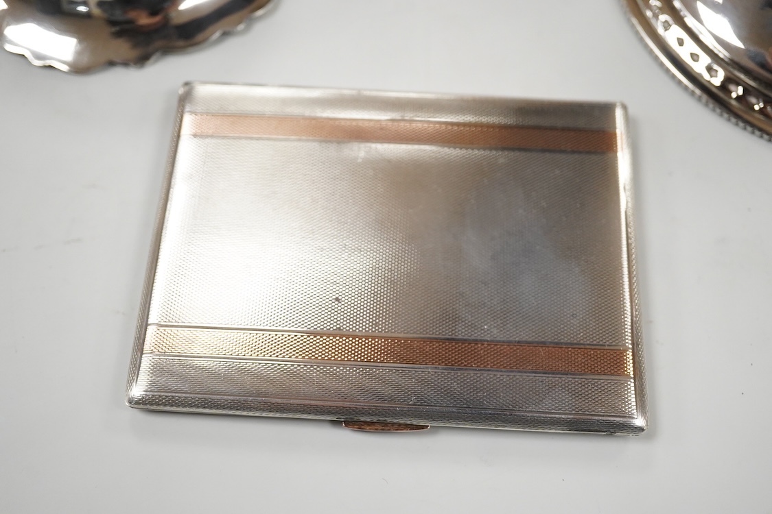 A George V silver pedestal bon bon dish, Sheffield, 1921, diameter 13.2cm, one other earlier silver dish by Josiah Williams & Co, London, 1904 and a silver cigarette case. and a cigarette case, gross 11.5oz.